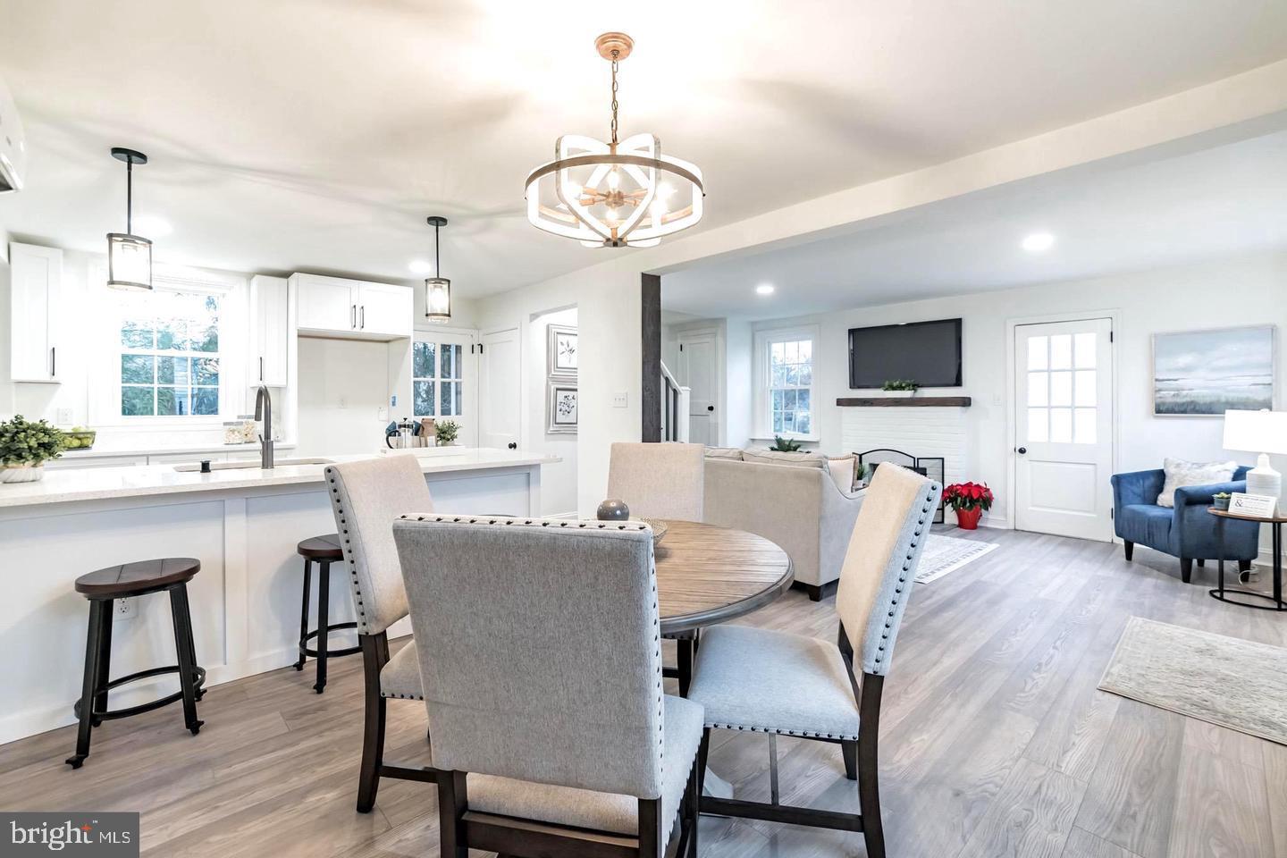 115 Beech Road Wallingford, PA 19086 - Photo 8 of 29 a view of a dining room with furniture a chandelier and wooden floor