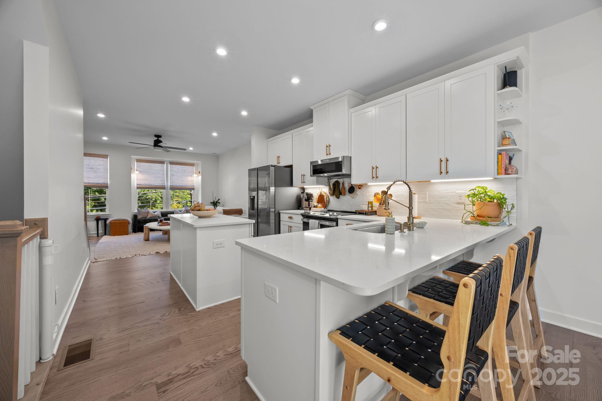544 Billingsley Road Charlotte, NC 28211 - Photo 11 of 24 a kitchen with a sink a stove and chairs