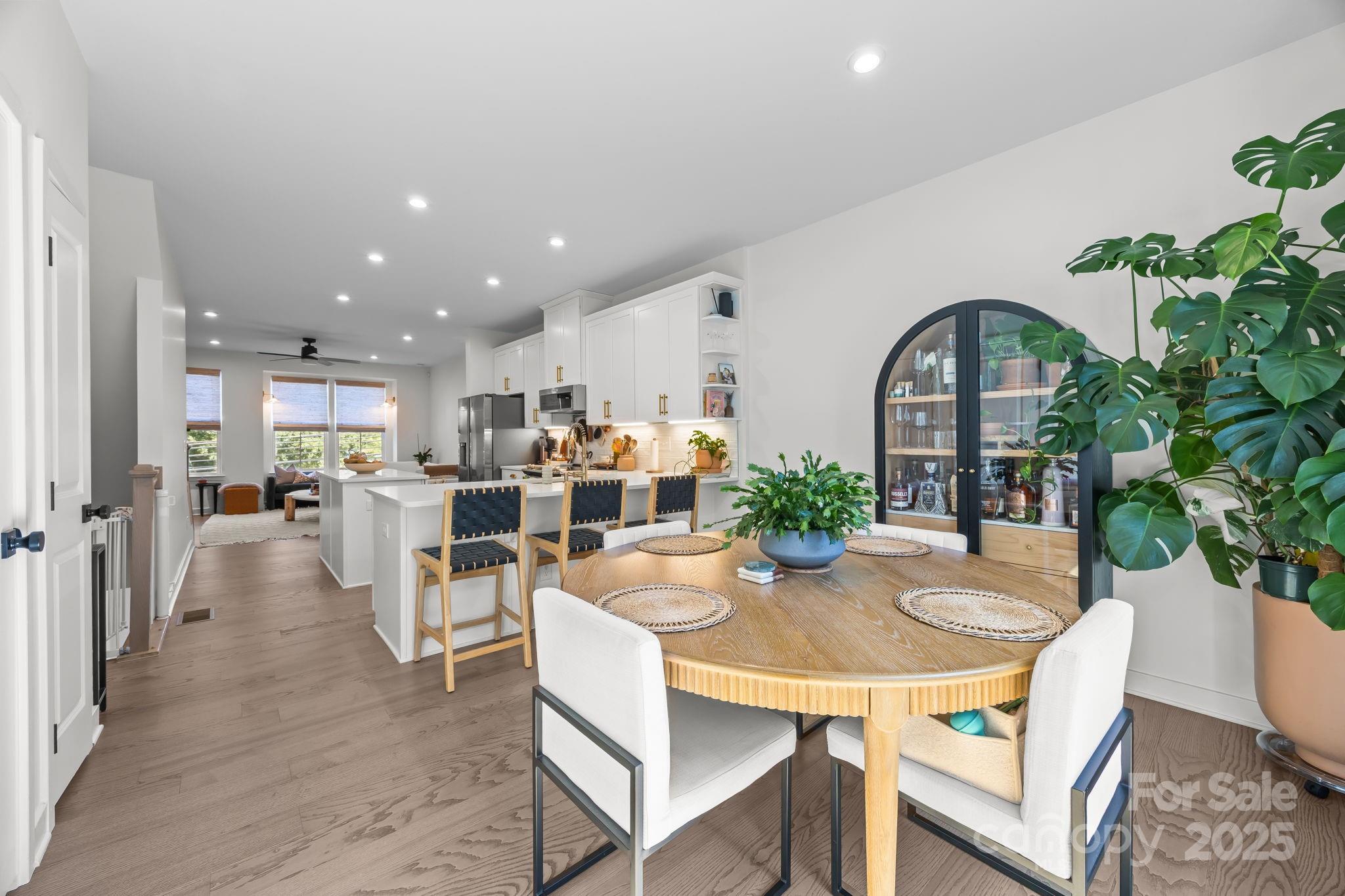 544 Billingsley Road Charlotte, NC 28211 - Photo 10 of 24 a dining room with furniture potted plants and wooden floor