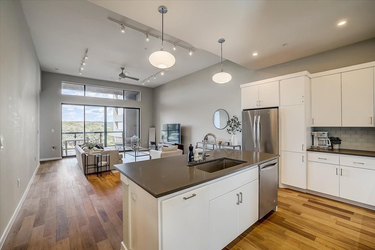 5921 Hiline Road, Unit 1204 Austin, TX 78734 - Photo 35 of 36 Kitchen with open floor plan, white cabinets, tasteful backsplash, and stainless steel appliances