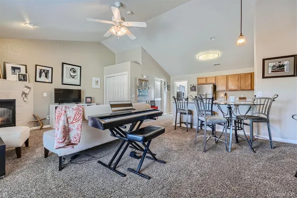 a living room with furniture and a dining table with wooden floor