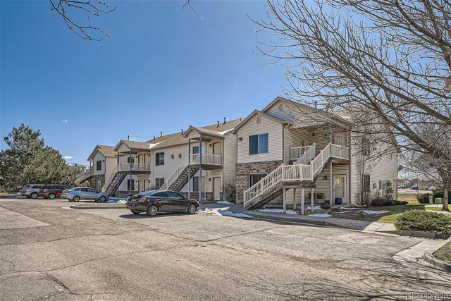 a view of a house with yard and utility