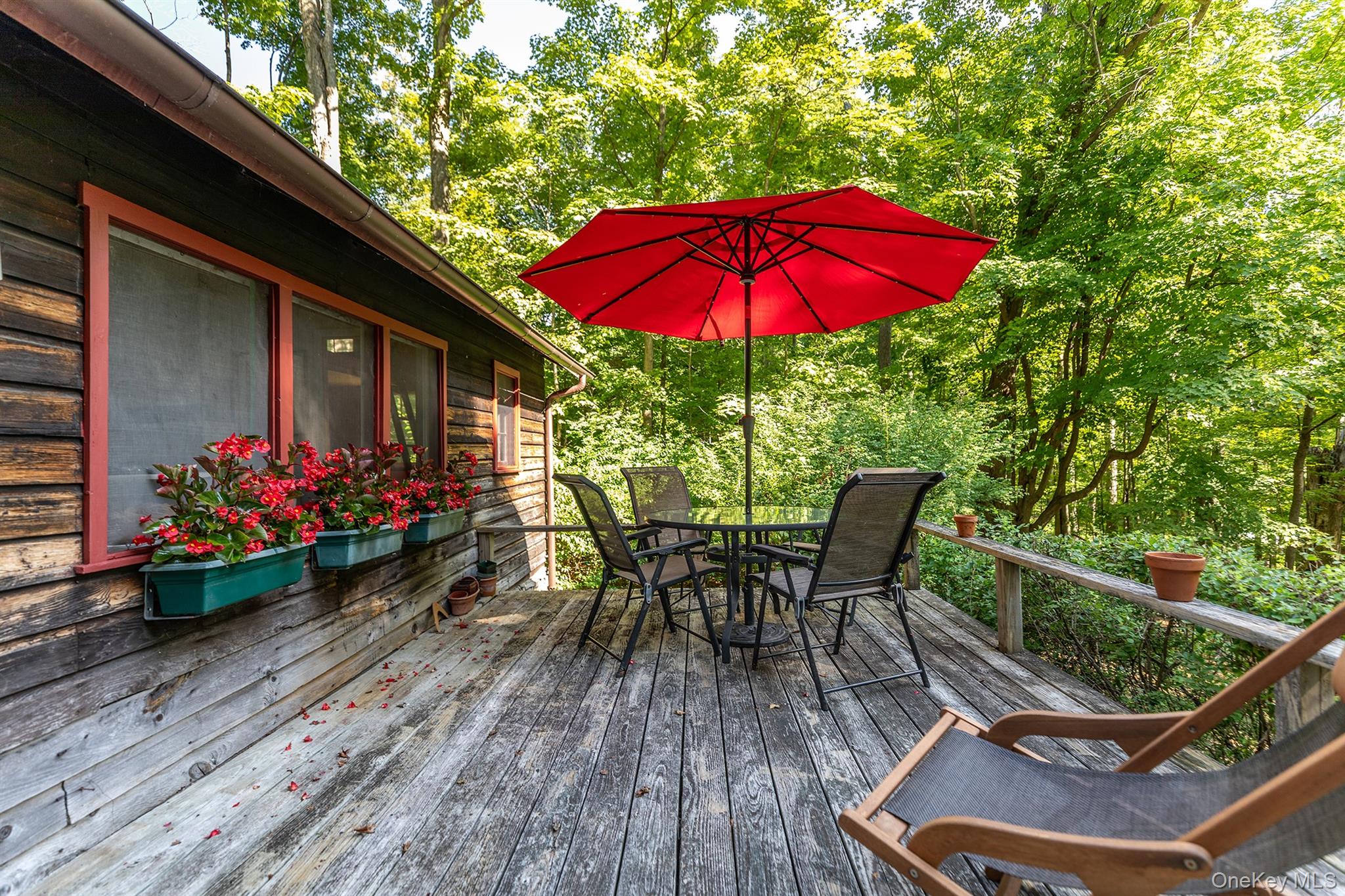 Undisclosed Address Brewster, NY 10509 - Photo 23 of 39 a view of a chairs and table under an umbrella