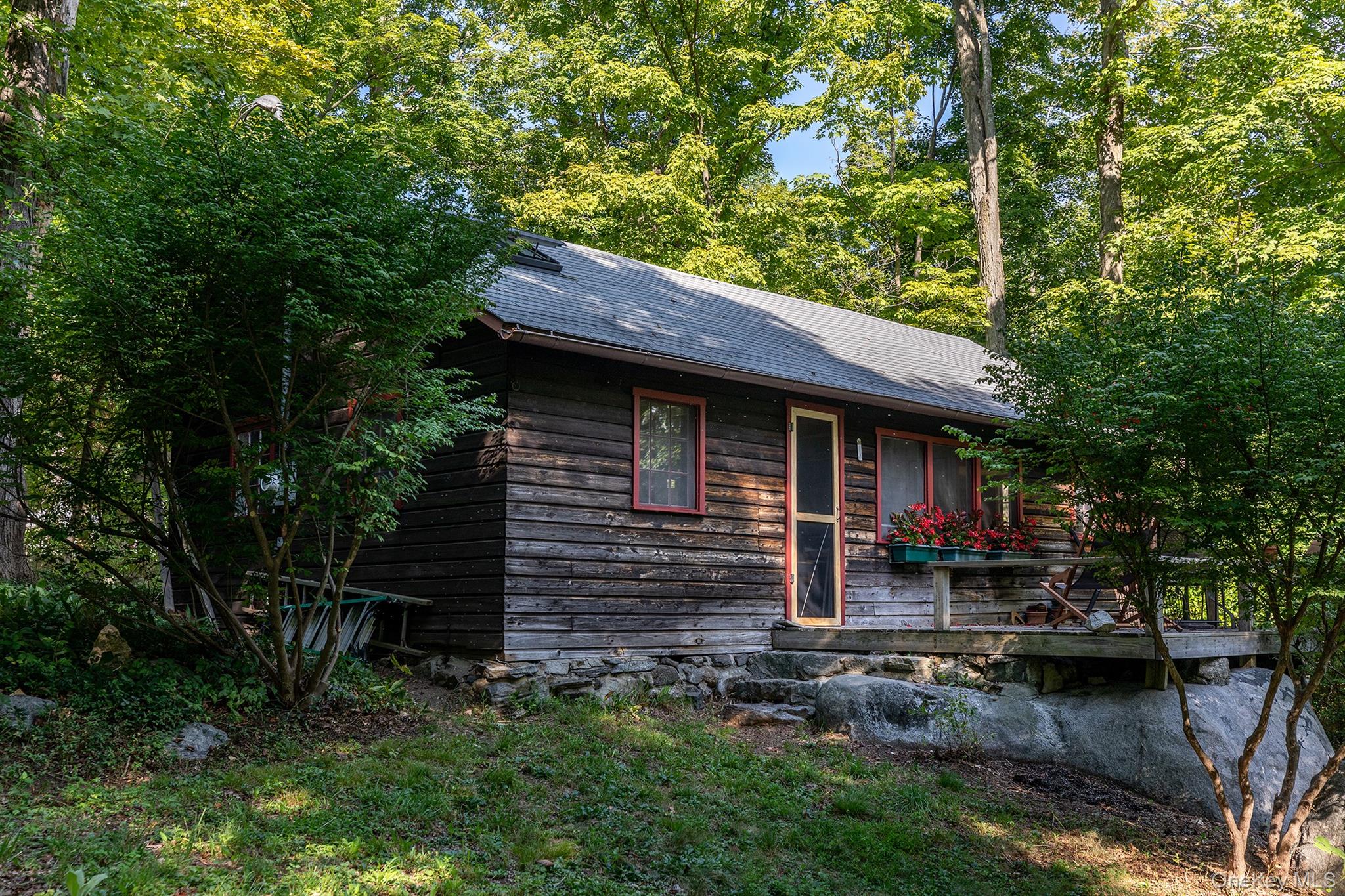 Undisclosed Address Brewster, NY 10509 - Photo 28 of 39 a backyard of a house with barbeque oven table and chairs