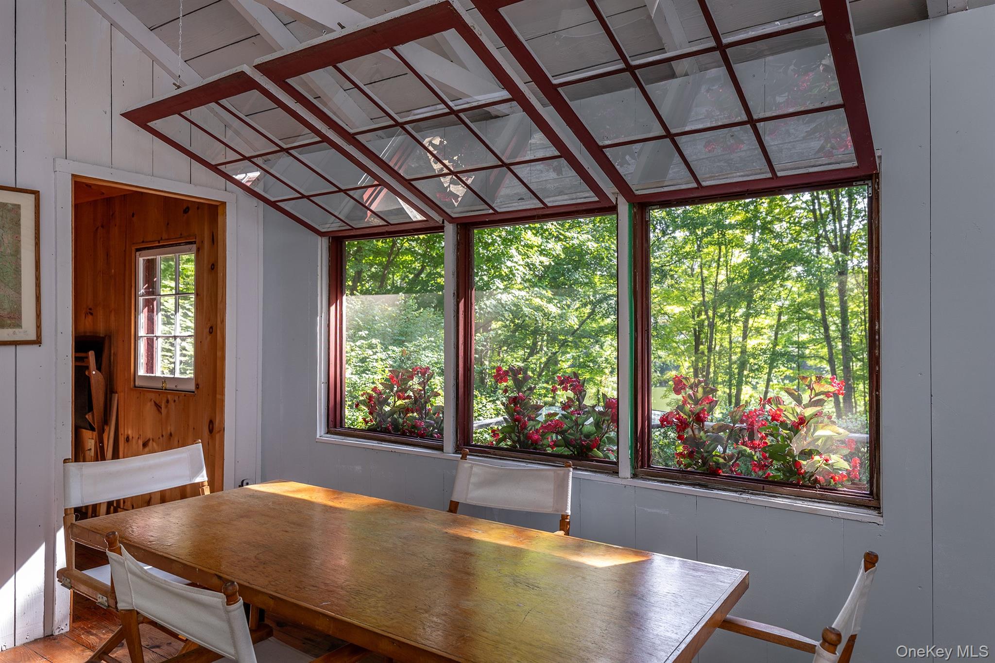 Undisclosed Address Brewster, NY 10509 - Photo 6 of 39 a view of a dining room with furniture large windows and wooden floor