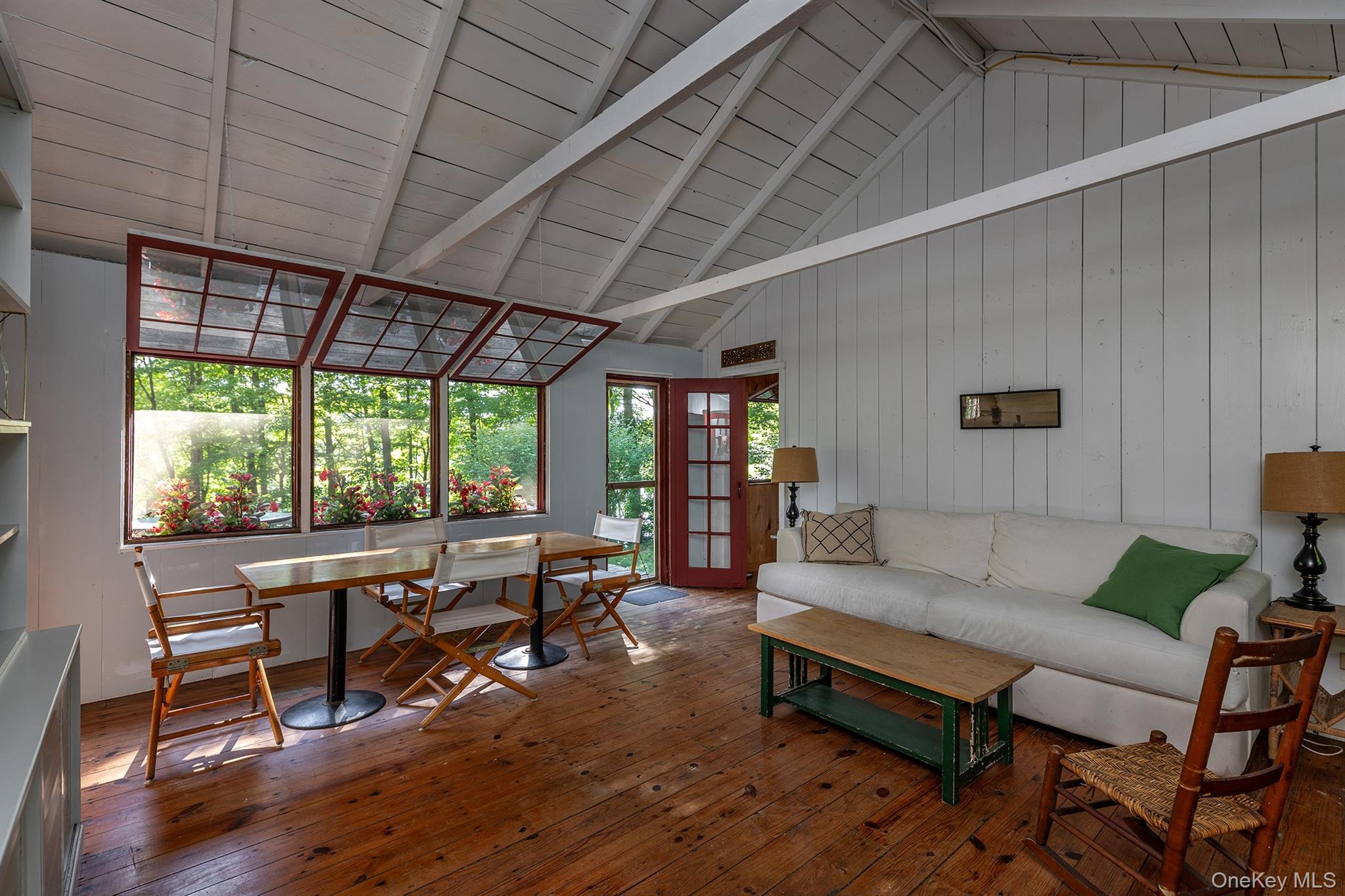 Undisclosed Address Brewster, NY 10509 - Photo 7 of 39 a living room with furniture a wooden floor and a table