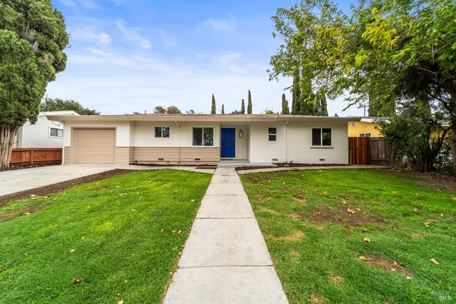 a front view of house with yard and green space