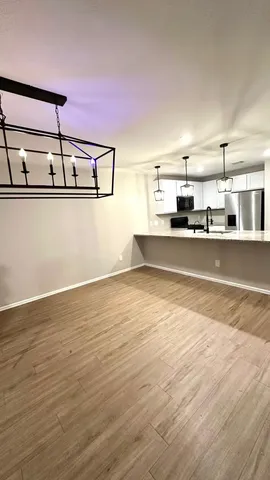 a view of a room with wooden floor