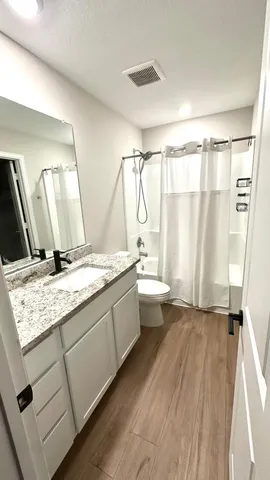 a kitchen with granite countertop a sink stove and refrigerator
