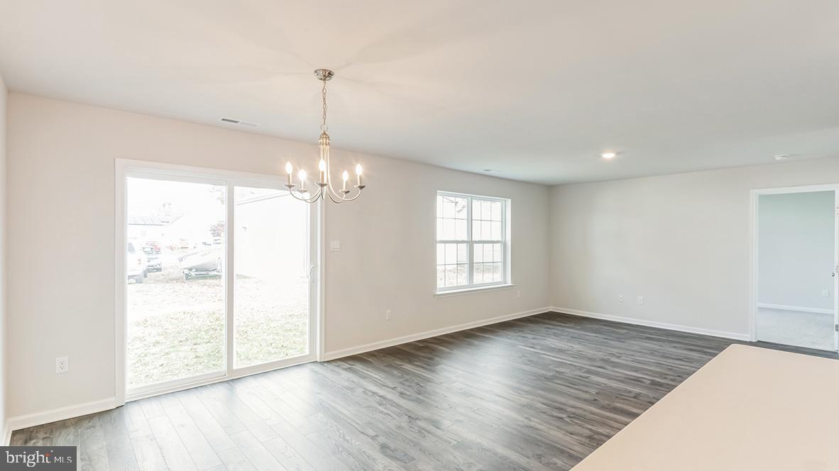 317 Vero Road Egg Harbor Township, NJ 08234 - Photo 6 of 14 a view of an empty room with wooden floor and a window