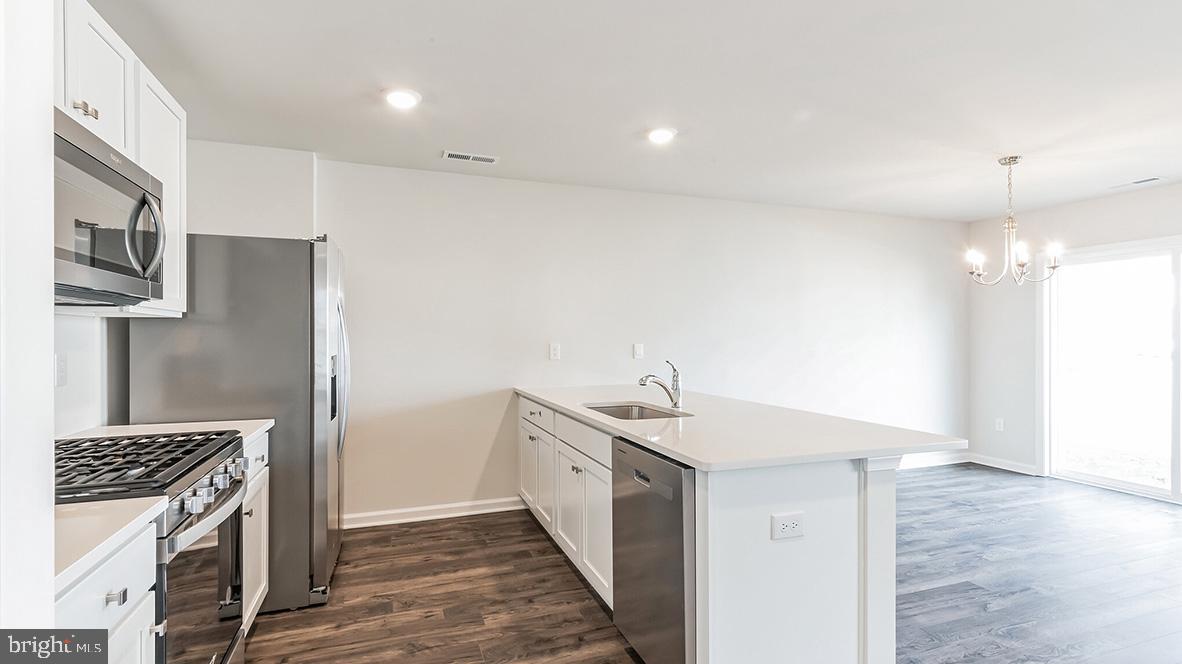 317 Vero Road Egg Harbor Township, NJ 08234 - Photo 7 of 14 a kitchen with a sink and a refrigerator