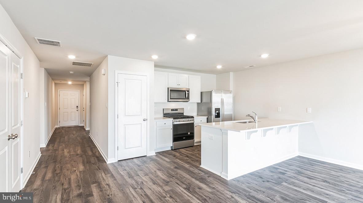 317 Vero Road Egg Harbor Township, NJ 08234 - Photo 8 of 14 a kitchen with a sink wooden floor and stainless steel appliances