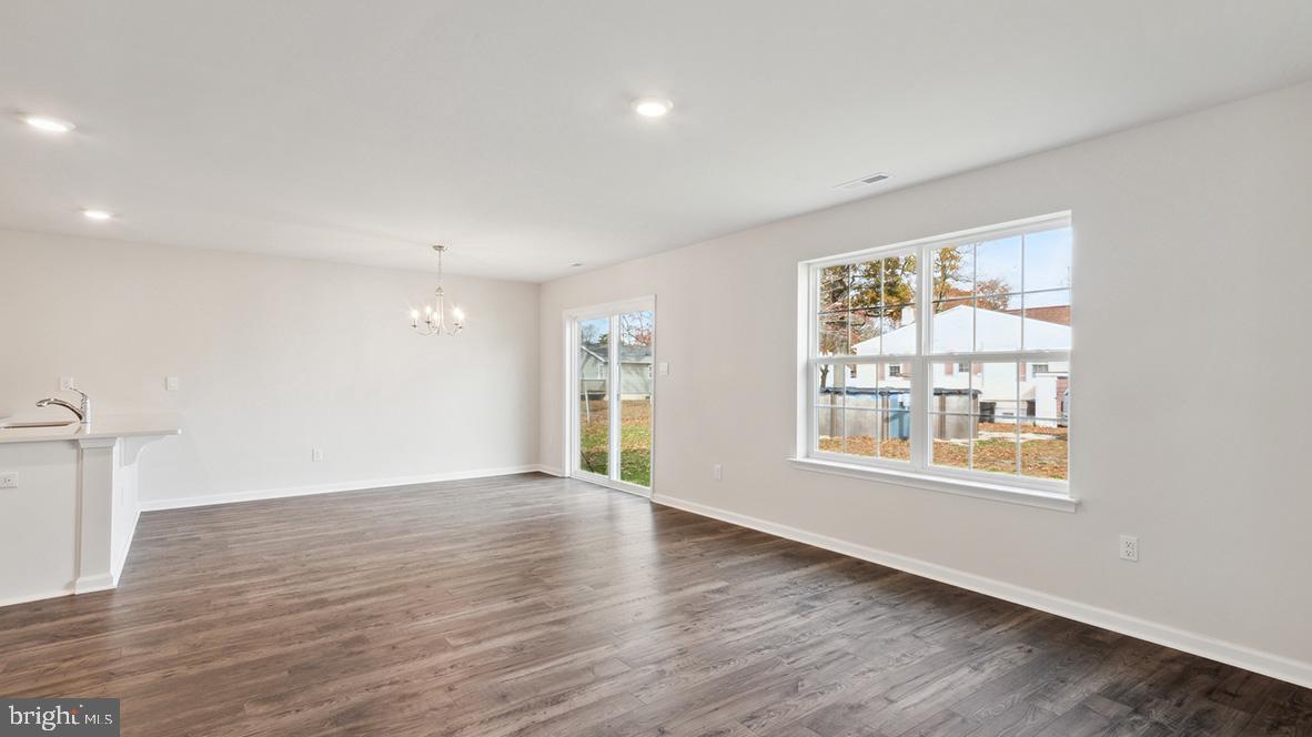 317 Vero Road Egg Harbor Township, NJ 08234 - Photo 9 of 14 an empty room with wooden floor and windows