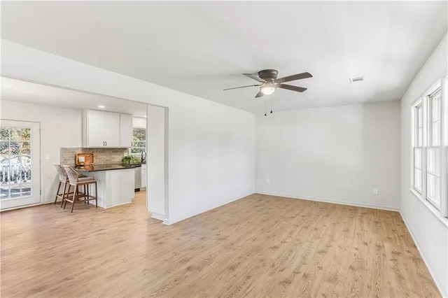wooden floor in an empty room with a window