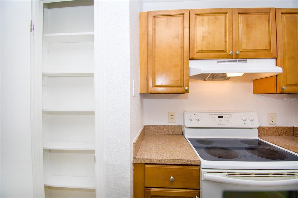 13830 Orange Sunset Drive, Unit 202 Tampa, FL 33618 - Photo 14 of 34 a kitchen with a stove and a microwave