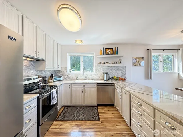 a kitchen with a sink stove and cabinets
