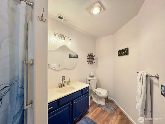 a bathroom with a sink mirror and toilet