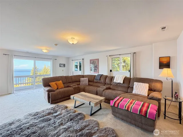 a living room with furniture lamp and window