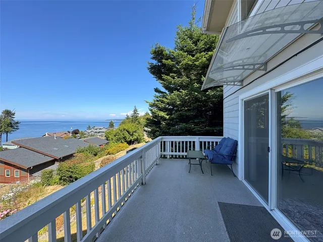a view of balcony with wooden floor and seating space