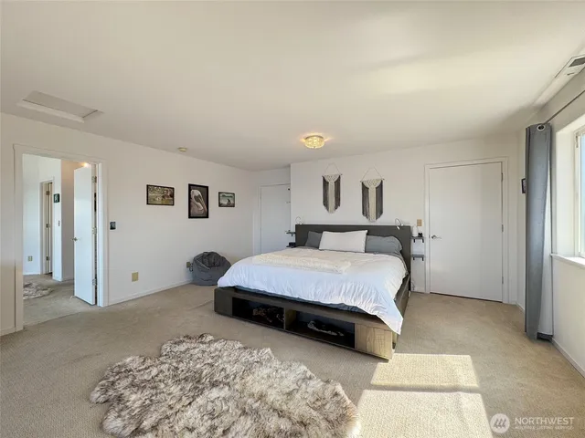 a bedroom with a bed and a couch