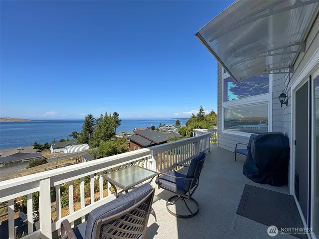 a view of a balcony with chairs