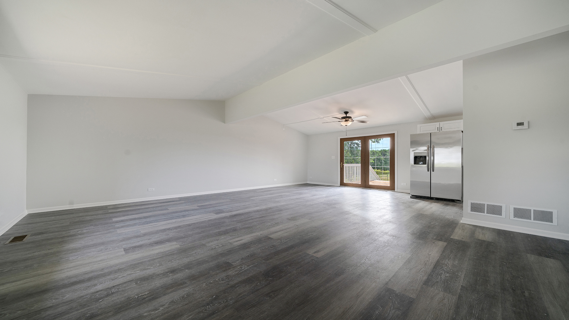 22005 Harmony Road Marengo, IL 60152 - Photo 9 of 49 an empty room with wooden floor and windows