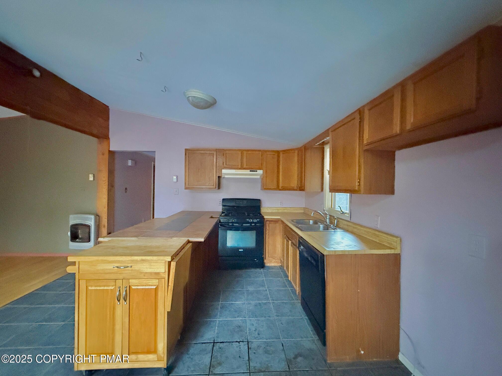 136 Pine Run Pocono Lake, PA 18347 - Photo 10 of 23 a kitchen with stainless steel appliances granite countertop a sink and a stove top oven