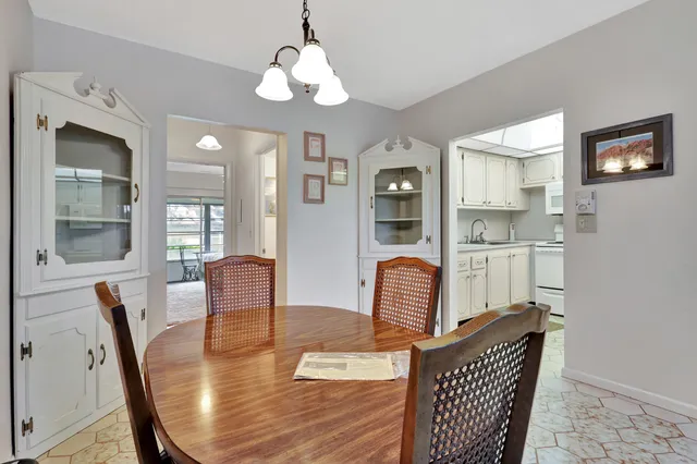 a living room with furniture wooden floor and a chandelier