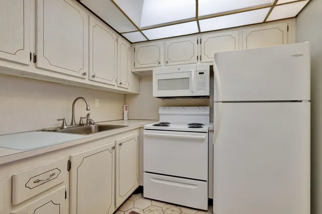a white refrigerator freezer sitting inside of a kitchen
