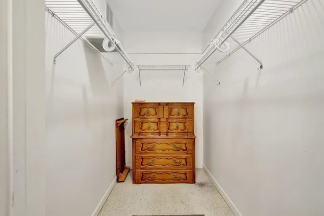 a view of walk in closet with clothes