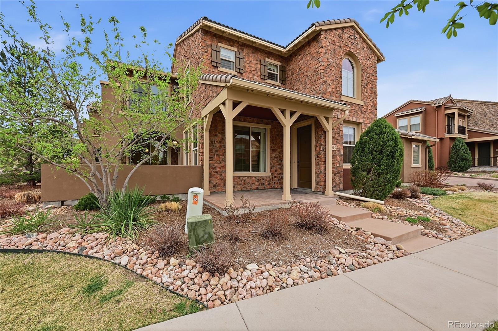 a front view of a house with garden