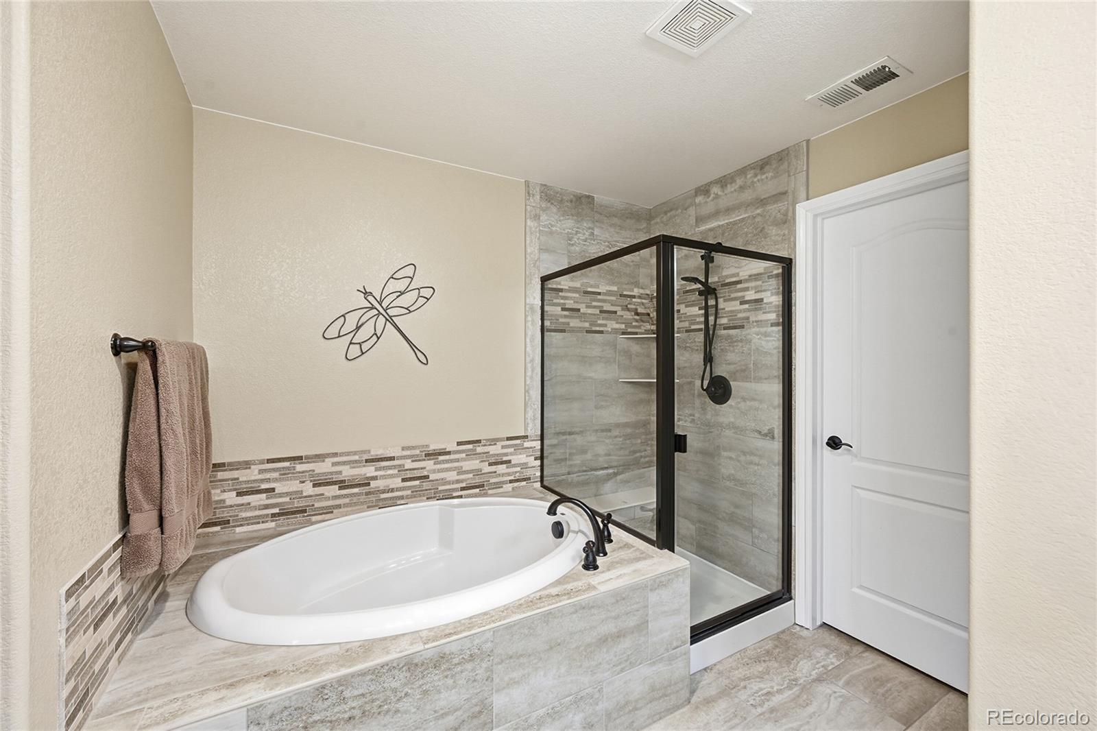 9500 Pendio Court Highlands Ranch, CO 80126 - Photo 11 of 15 a bathroom with a bathtub and a shower