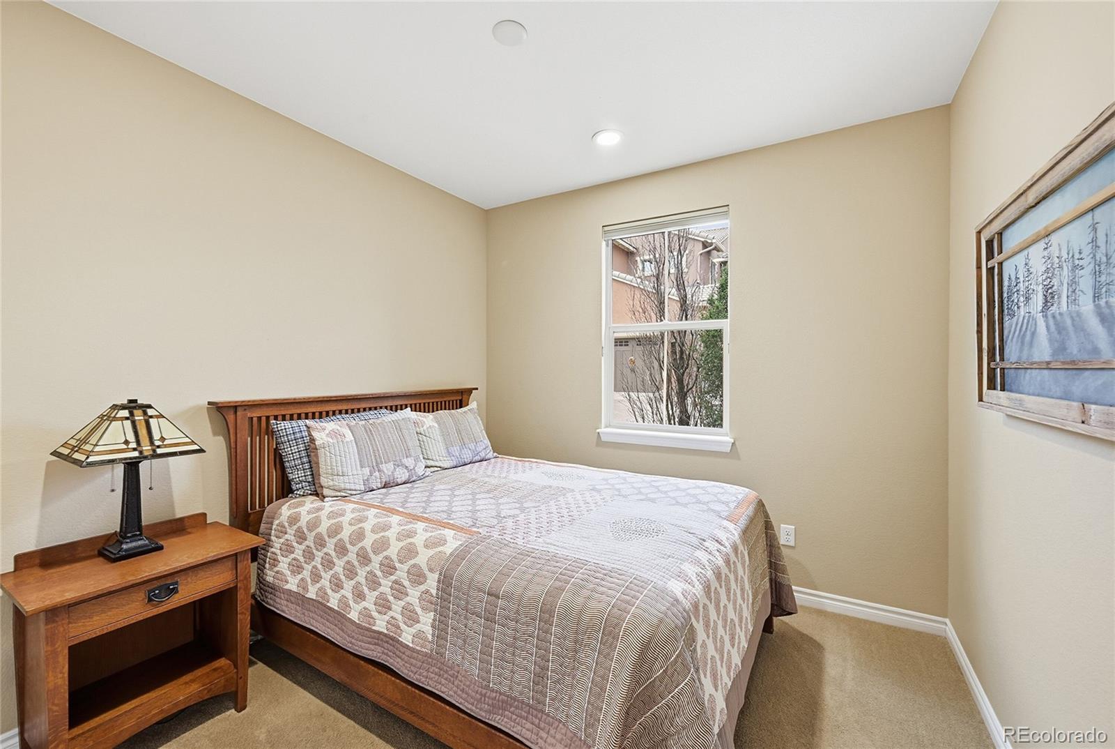 9500 Pendio Court Highlands Ranch, CO 80126 - Photo 12 of 15 a bedroom with a bed a painting on the wall and a window