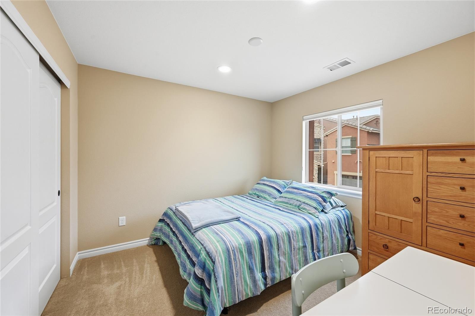 9500 Pendio Court Highlands Ranch, CO 80126 - Photo 14 of 15 a bedroom with a bed and closet