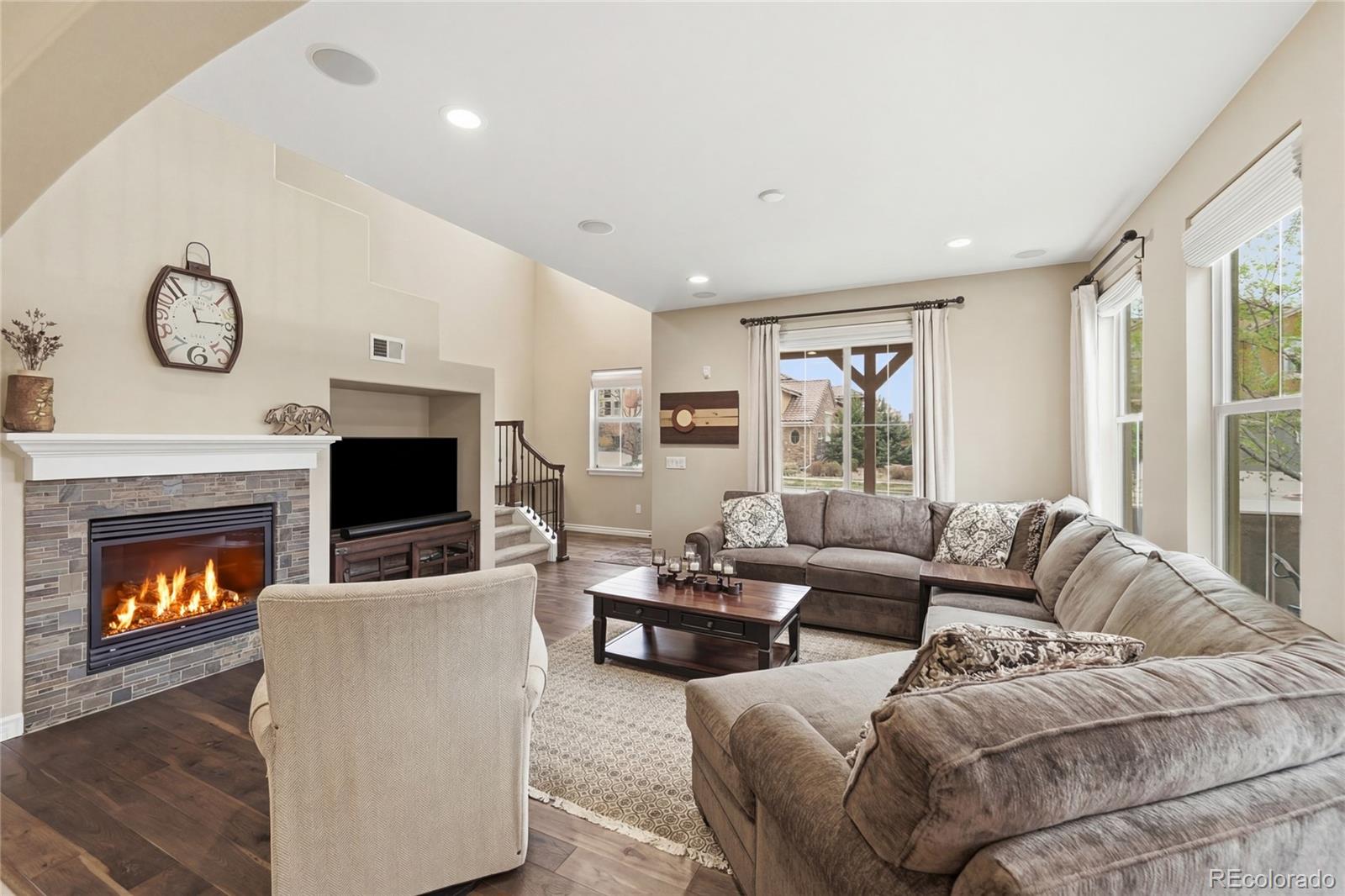9500 Pendio Court Highlands Ranch, CO 80126 - Photo 3 of 15 a living room with furniture a fireplace and a large window