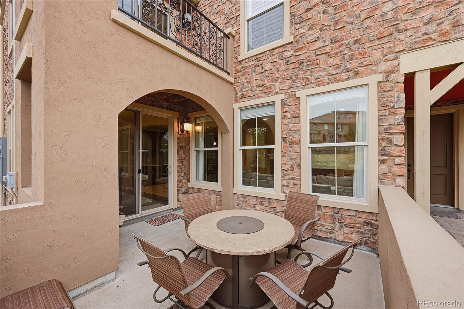9500 Pendio Court Highlands Ranch, CO 80126 - Photo 8 of 15 a front view of a house with outdoor seating
