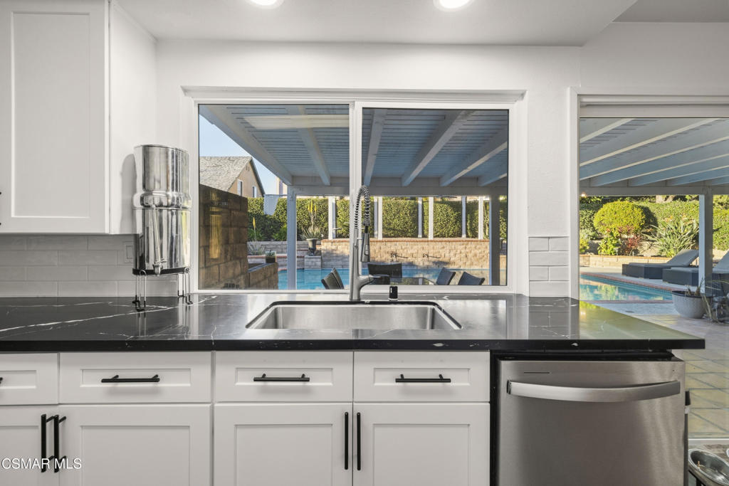 2371 Larch Street Simi Valley, CA 93065 - Photo 13 of 40 a kitchen with stainless steel appliances granite countertop white cabinets and a large window
