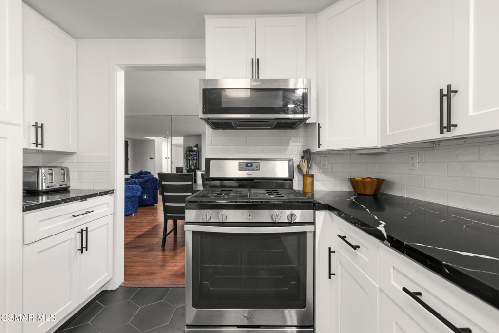 2371 Larch Street Simi Valley, CA 93065 - Photo 14 of 40 a kitchen with stainless steel appliances granite countertop a stove and a microwave