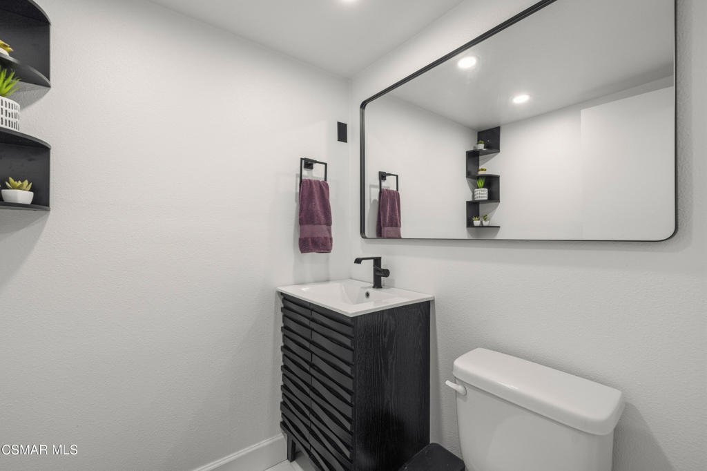 2371 Larch Street Simi Valley, CA 93065 - Photo 15 of 40 a bathroom with a sink a toilet and mirror