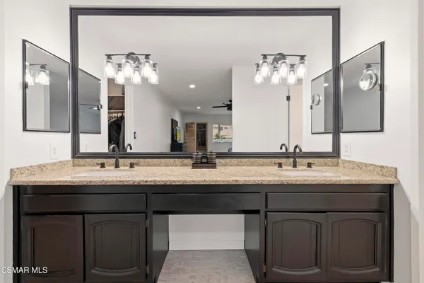 a bathroom with a double vanity sink and a mirror