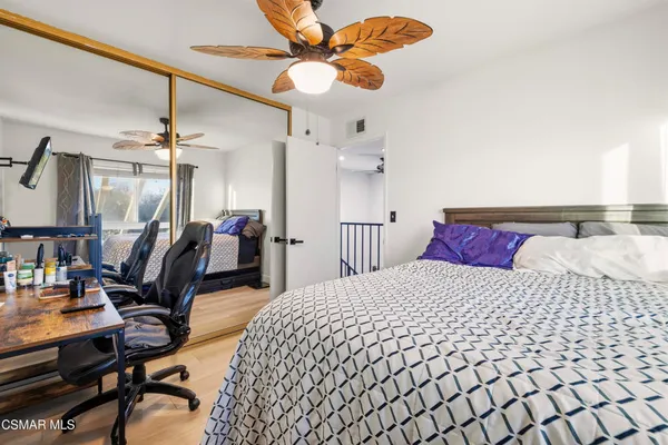 a bedroom with a bed a desk and chair