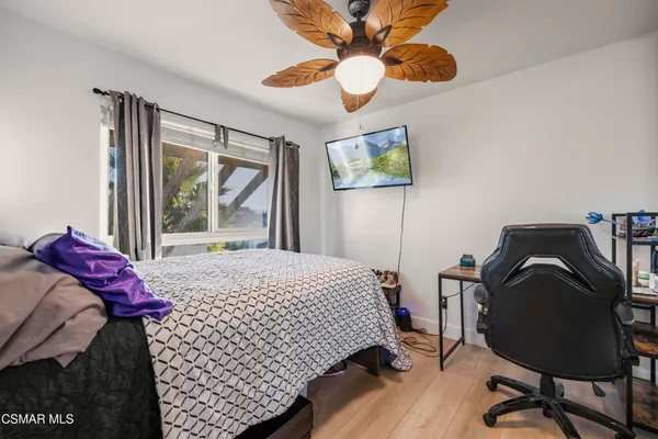 a bedroom with a bed and a desk