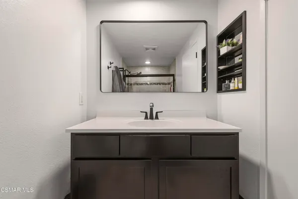 a kitchen with a sink and a mirror