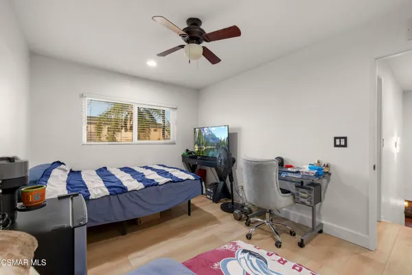 a bedroom with furniture and a window