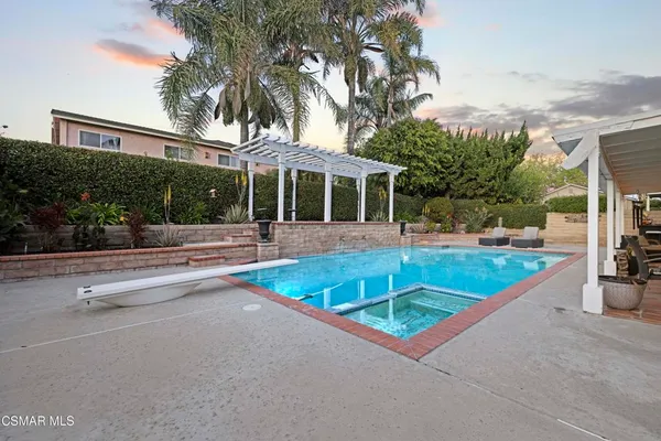 a view of a patio with a table and chairs