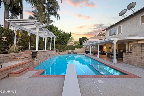 swimming pool view with a seating space and a garden view