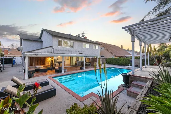a view of a patio with swimming pool table and chairs