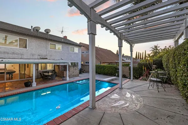 a view of a chairs and table in the patio