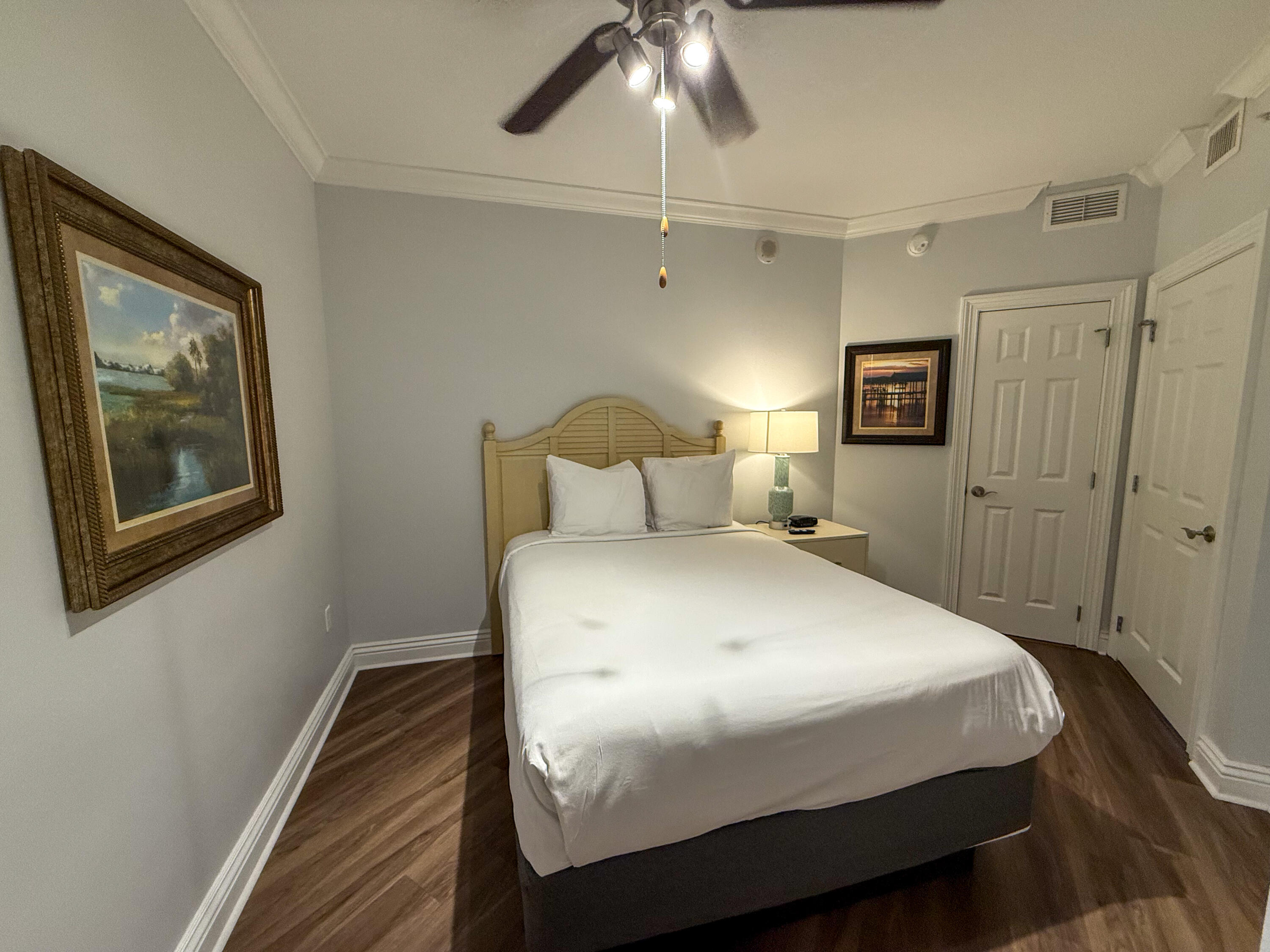 10 Harbor Boulevard, Unit E505F Destin, FL 32541 - Photo 15 of 25 a bedroom with a bed and wooden floor