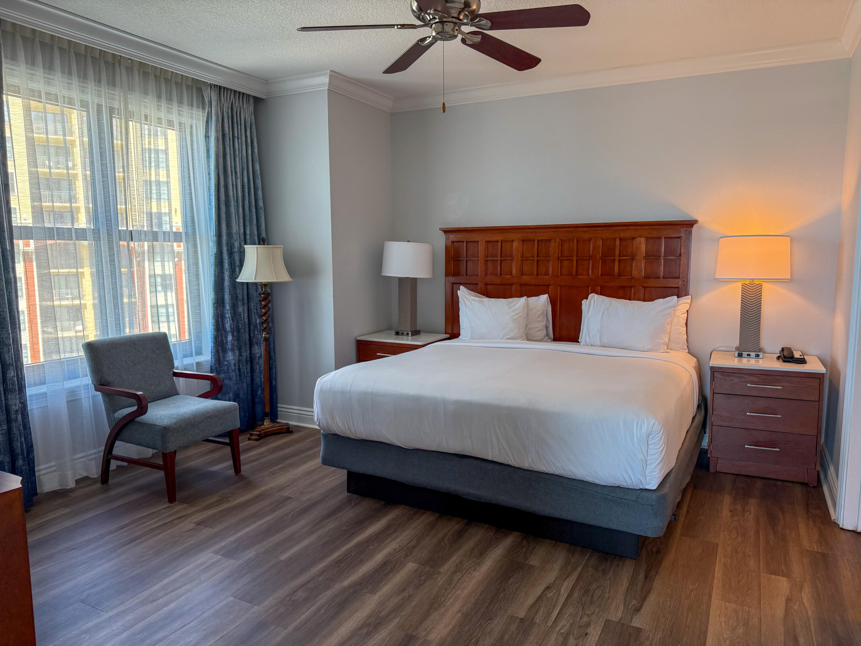 10 Harbor Boulevard, Unit E505F Destin, FL 32541 - Photo 8 of 25 a bedroom with furniture and a wooden floor